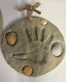 Hotel staff folding laundry and interacting in a utility room.