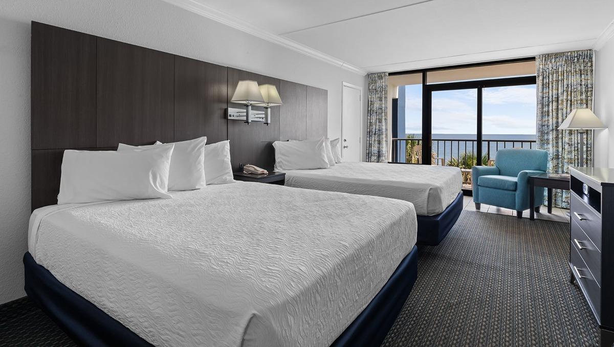 oceanfront hotel room with 2 queen beds and a balcony view of the ocean