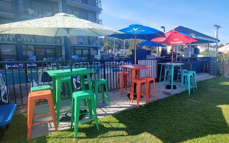 Outdoor seating area with colorful chairs, tables and umbrellas