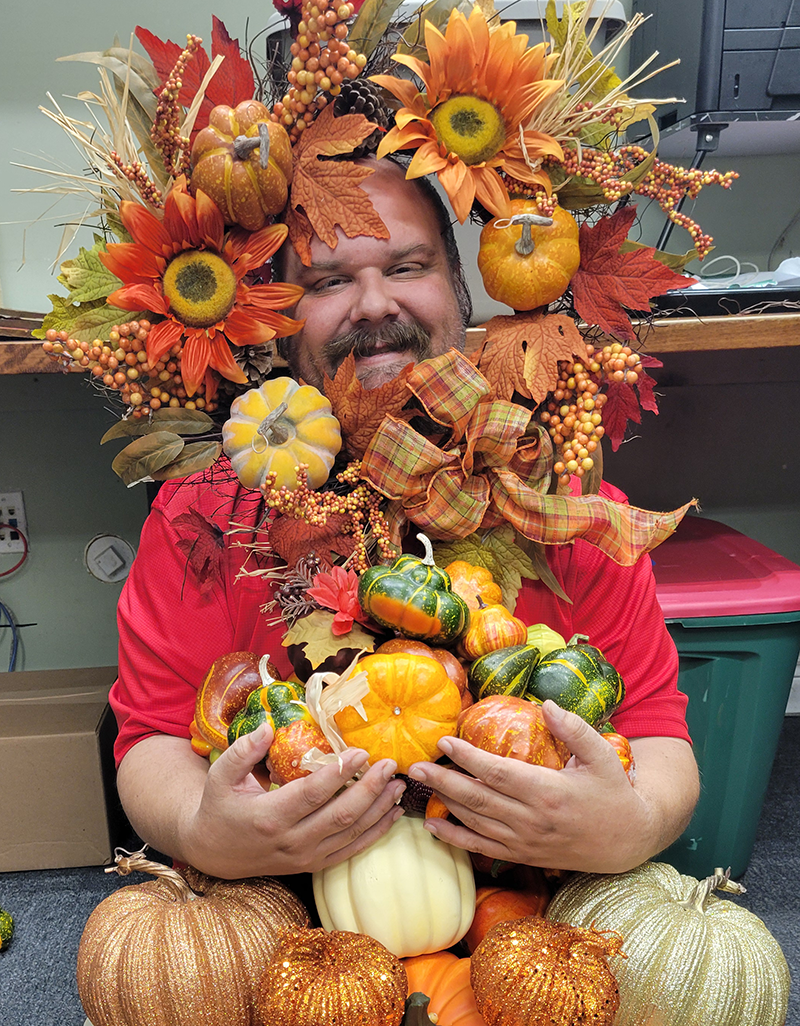 Smiling man holding pumpkins