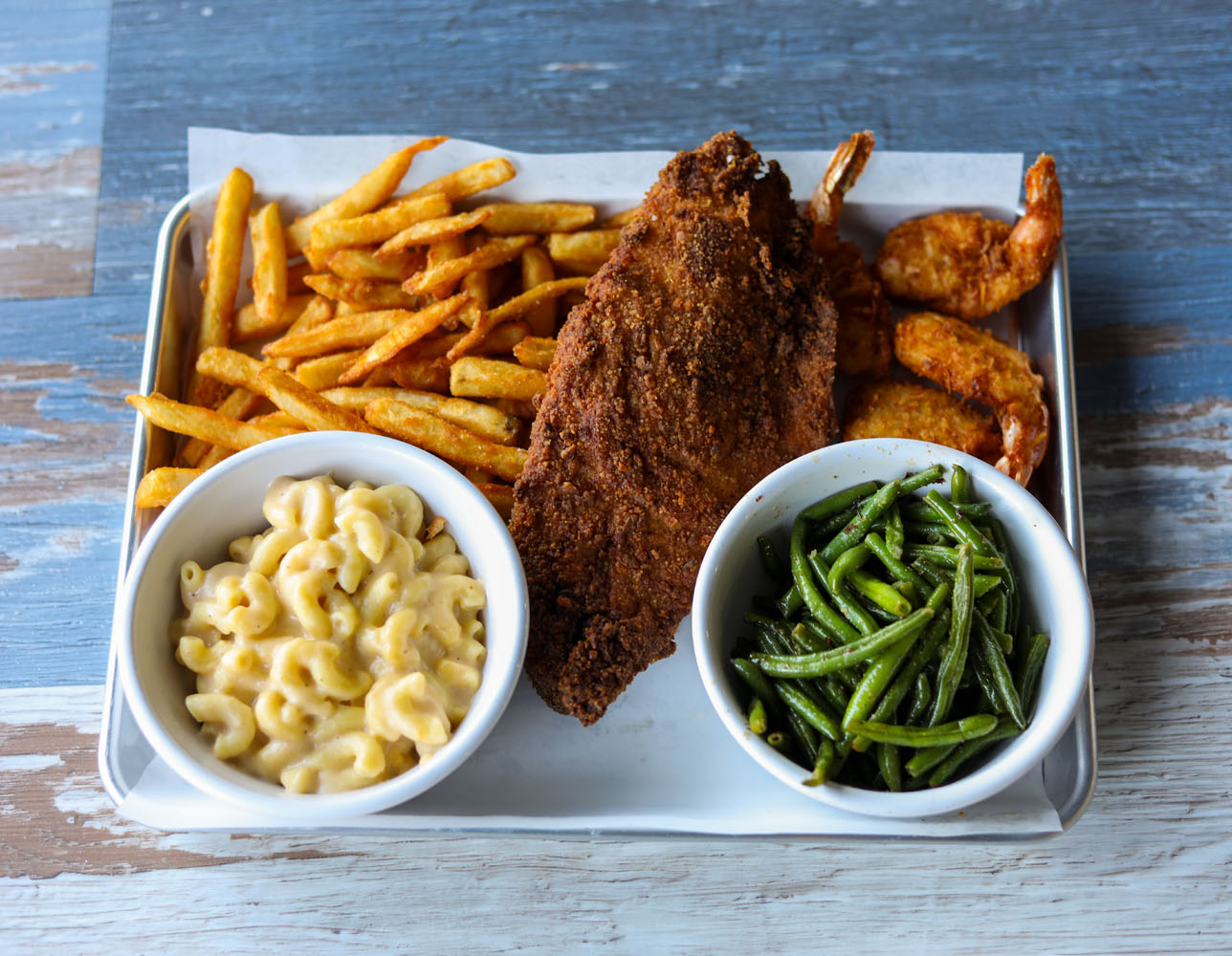 Plate with grilled salmon, mixed vegetables and a lemon wedge