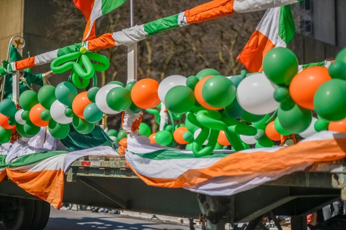 Float showcasing the irish flag with balloons and flags